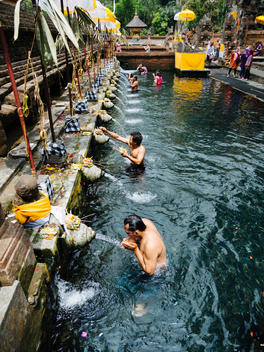 Balinese men cleanse themselves in the natural springs at Tirtha Empul Temple outside Ubud, Bali, Indonesia. (A water temple whose springs are known for their healing powers.)