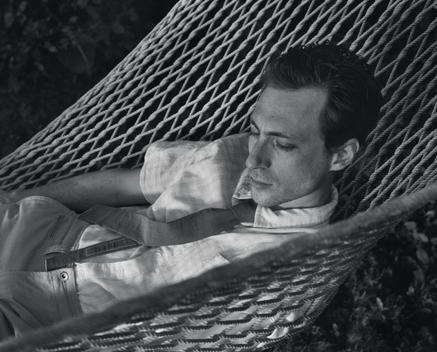 Man Lounging In Hammock With Tie.