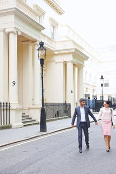 Couple Walking on City Street, London, England