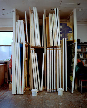 Stacked Canvas Paintings At An Art Studio