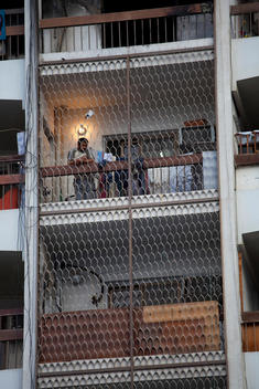 A Foreign Worker On The Balcony Of His Apartment In Abu Dhabi, United Arab Emirates.