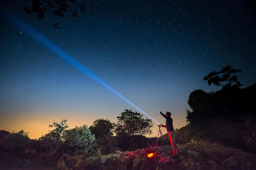 man with a torch under a starry sky