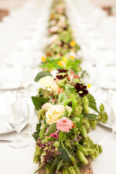 table runner of flowers on wedding table