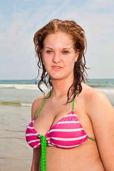 Portrait Of A Woman Wearing A Bikini At The Beach, Tybee Island, Georgia, Usa.