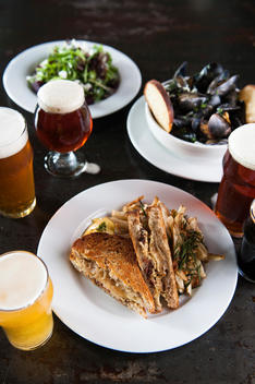 Saison-style mussels with matching beer, artisanal grilled cheese sandwich with local cheese & house smoked bacon; seasonal farm-fresh salad with mixed greens and beets.