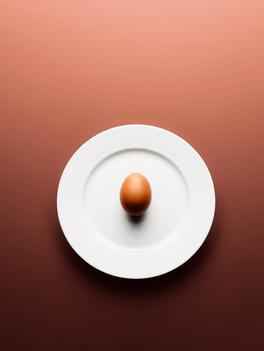 An egg on a plate top down.