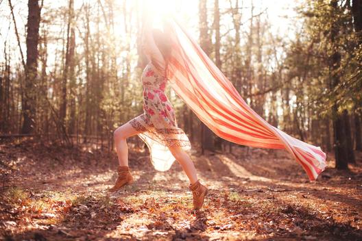 Picture of young woman running with blanket in forest, Massachusetts, USA