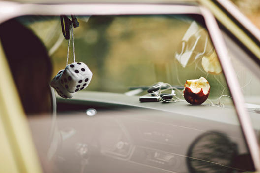 Vintage Green Car with White Fuzzy Dice Hanging, Half Eaten Apple and iPod