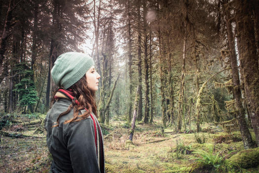 girl looking out at a forest