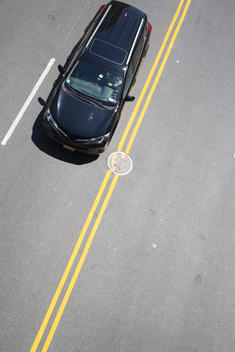 Overhead view of a car driving on a city street in Manhattan