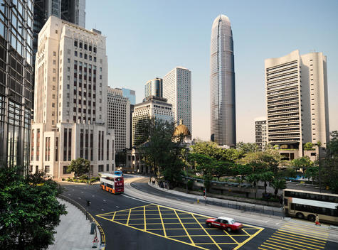 a street, junction in hong kong,with the international commerce center skyscraper in the back