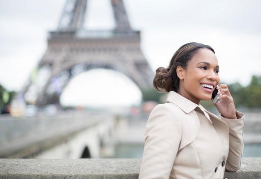 Businesswoman talking on cell phone near Eiffel Tower, Paris, France