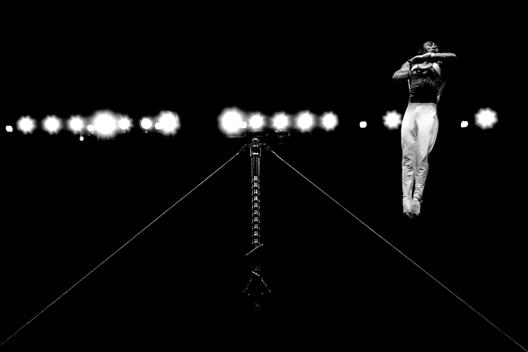 A male gymnast dismounts the high bar in the Tyson American Cup held in Philadelphia, Pennsylvania.