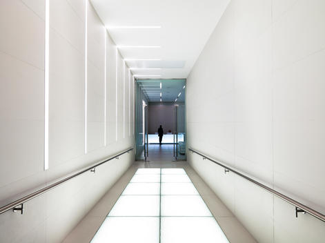 Minimal white reception area at Progressive Media HQ, London.