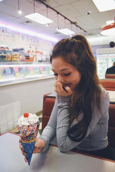 Girl laughing at an ice cream parlor