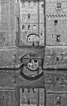 A man trapped in the architecture of the castle of Ferrara - (Candid urban street)