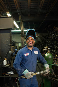 African welder working in repair shop