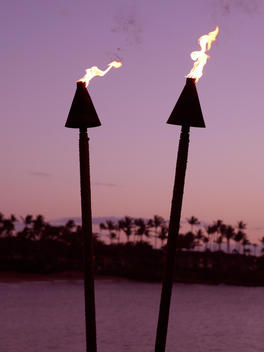 Tiki torches at sunset.