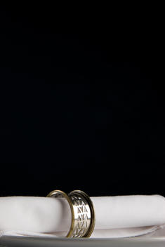 Close up of a napkin and silver napkin ring