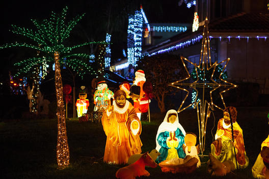 Nativity scene in a front yard at night.