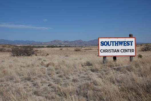 sign saying Southwest Christian Center on open plains under blue sky