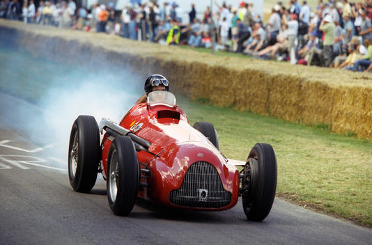 Tv Presenter And Journalist James May Tears Down The Lavant Straight At Goodwood, Towards The Finishing Line In The Alfa Romeo 159 Alfetta, Passing Crowds Of Fans Lining The Course At The Goodwood Festival Of Speed.