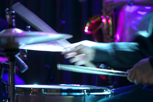 hands playing drums in a jazz band