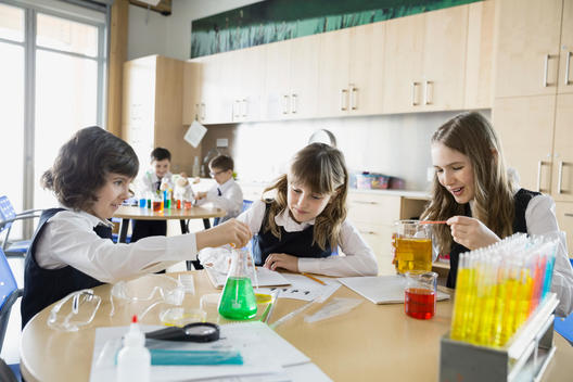 School girls conducting experiment in science classroom