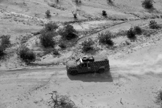 Tohno O\'odham Indian Reservation, Arizona USA August 24, 2007 Army National Guard helicopter pilot Major George Harris and another National Guard pilot spot two vehicles hidden in trees along a road that cuts illegally through an Indian reservation on wha