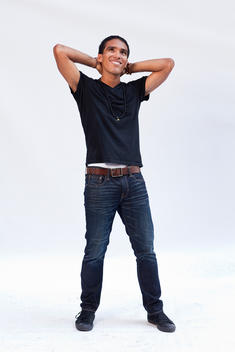 African-American Man, 20-30 Years Old, In Jeans, Black T-Shirt And Black Sneakers Striking Humorous Pensive Pose, Studio Portrait On White Background