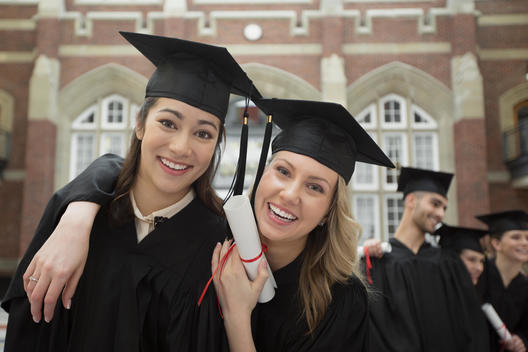 Portrait of confident college graduates with diploma