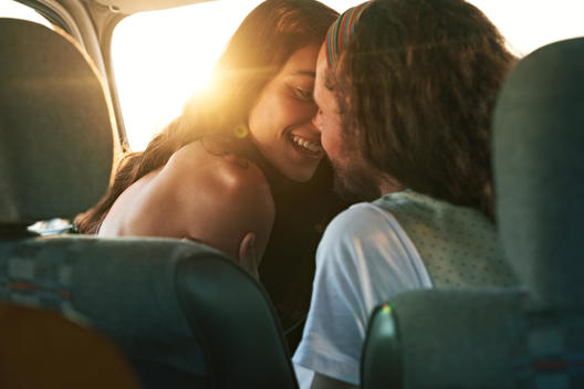 boy and girl kissing in car