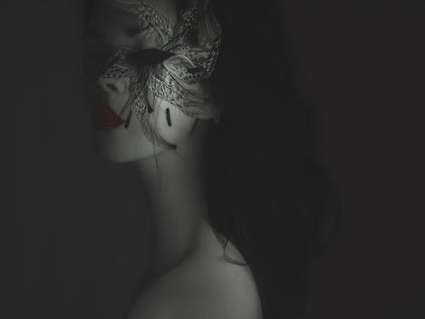 Concept close up of young female face wearing mask of flowers