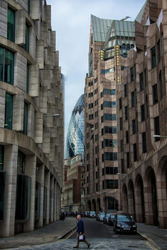 Man walking down street with london buildings in background