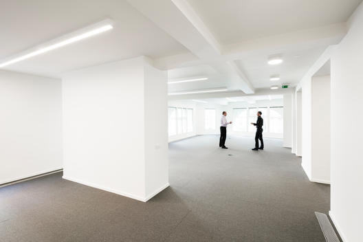 Minimal corporate office with two men on Oxford Street London, UK.