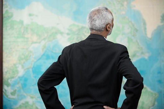 Black businessman viewing world map