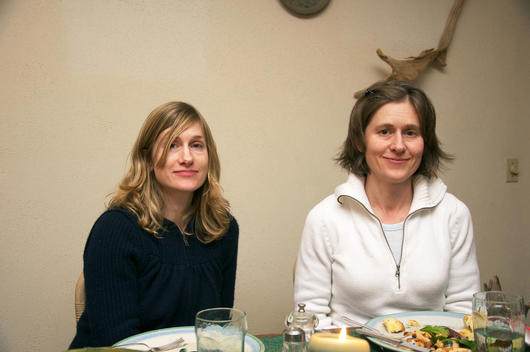 Two Sisters At Dinner Table