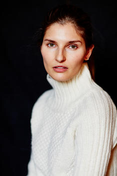 Woman in white sweater looking at camera
