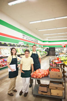 Workers in produce section of grocery store