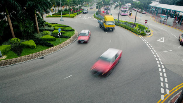 Cars With Motion Blur Drive Along A Street