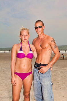 Portrait Of A Couple With Arms Around Each Other At The Beach, Tybee Island, Georgia, Usa.