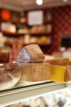 Gourmet Cheese In Saran Wrap On A Counter In A Store