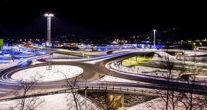Road network in winter surrounded by snow at night, Bergen, Norway.