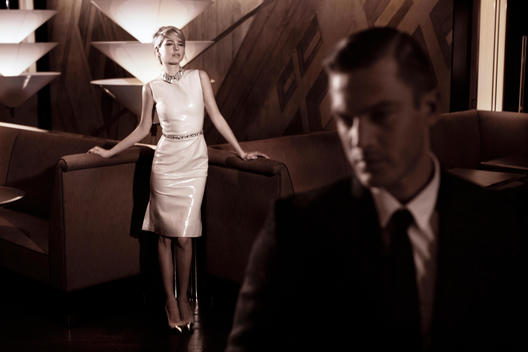 A model couple provide some cinematic tension in a dark 1950's styled hotel bar.