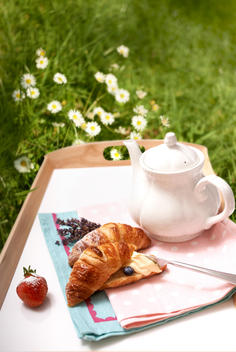 Tea and croissant on a tray