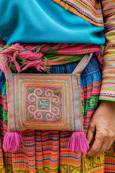Close up of woman wearing traditional purse and dress