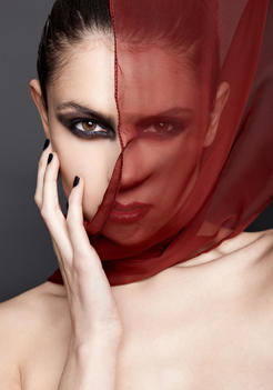 Young Woman With Red Scarf Covering Face, Fashion Portrait
