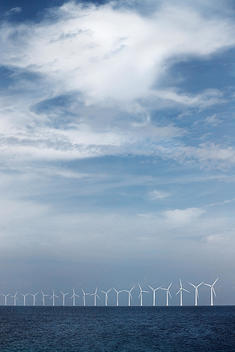 Wind Turbines In A Row Across Sea