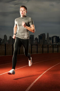 Runner On Red Track With New York City Skyline In Background.
