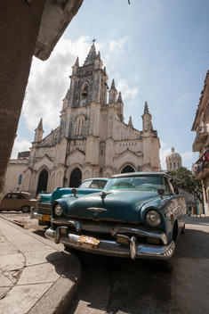 Vintage cars on Cuban street. One of Ernest Hemingway\'s favorite bars. There\'s a Bronze statue of him inside the bar